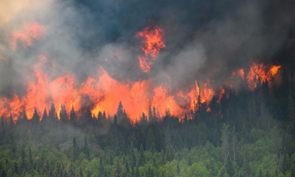A wildfire seen from a Canadian forces helicopter surveying the area near Mistissini, Quebec, on 12 June.