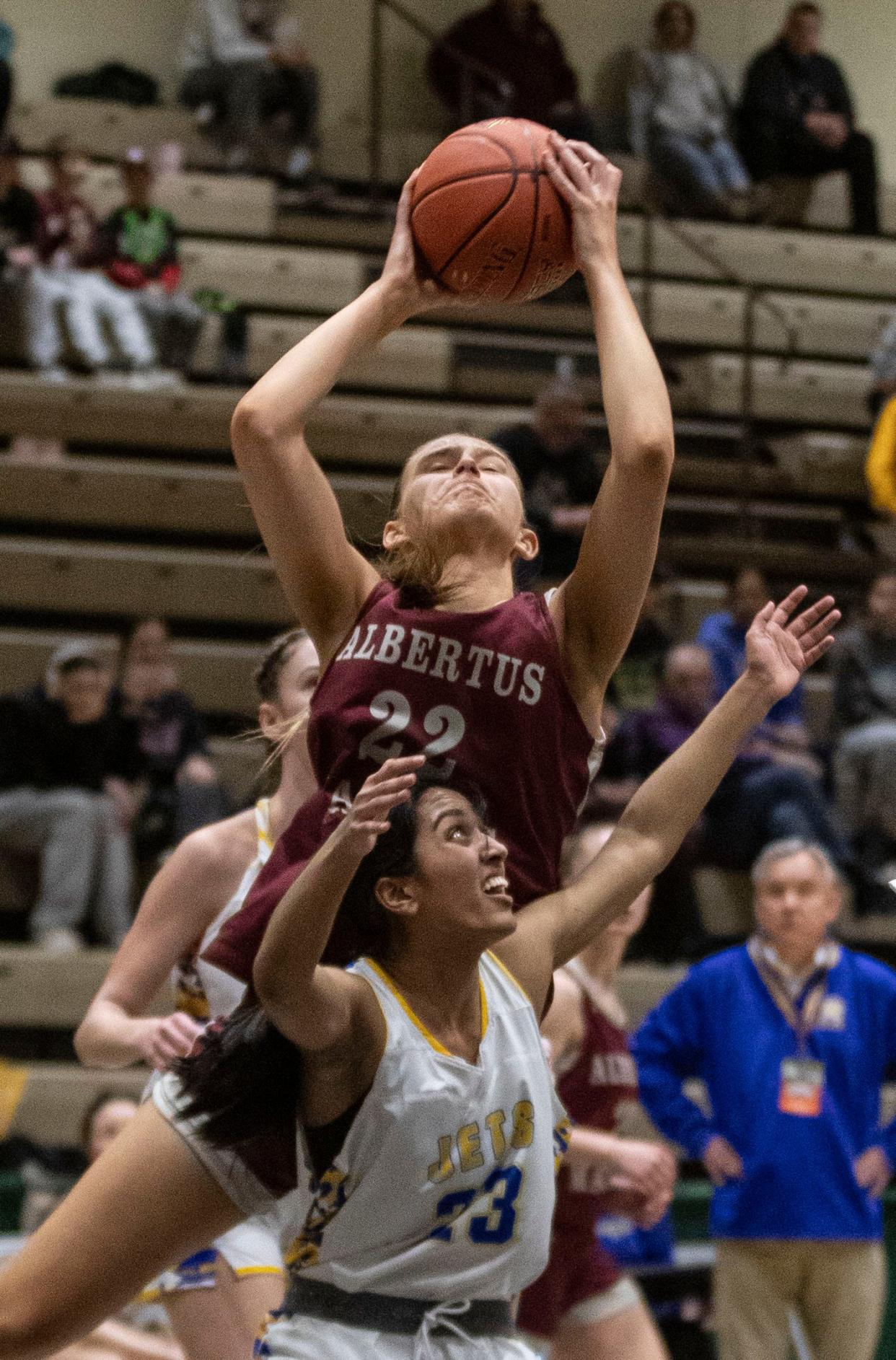 Julia Scott of Albertus Magnus pulls down a rebound over Keziah Philip of East Meadow during a New York State girls Class AA basketball semifinal against East Meadow at Hudson Valley Community College in Troy March 15, 2024. Albertus Magnus defeated East Meadow 89-51 to advance to the Class AA final on Saturday.