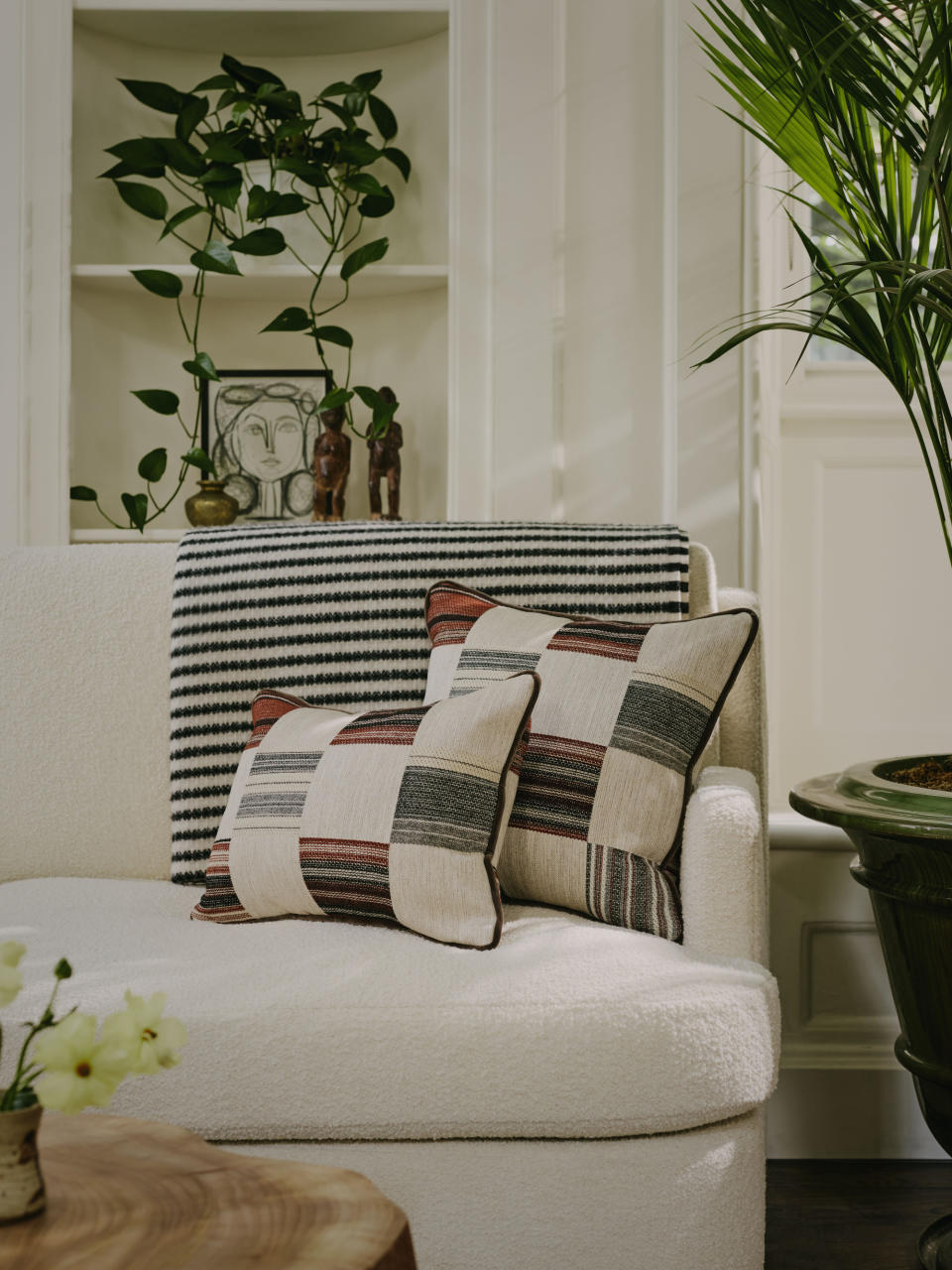 A living room with checkerboard print couch pillows