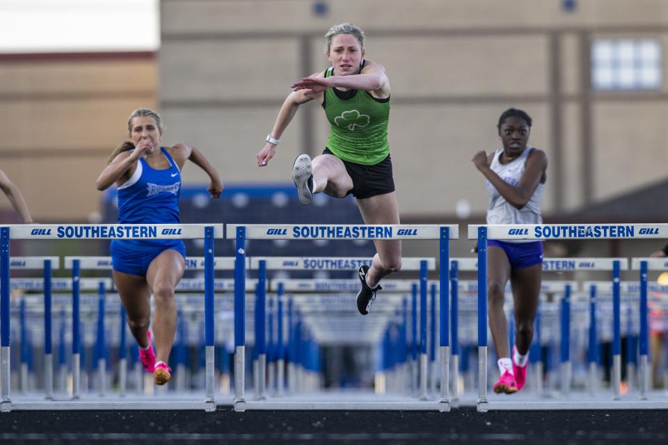 Westfield High School junior Lucy Hauser, center, competes in the 100m Hurdles during a Hoosier Crossroad Conference girlsâ€™ track meet, Wednesday, May 3, 2023, at Hamilton Southeastern High School.