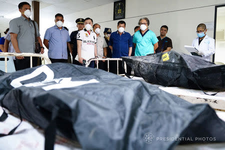 Philippines' President Rodrigo Duterte visits the remains of the victims, who died in the recent fire incident at the New City Commercial Center (NCCC) mall, at the Southern Philippines Medical Center (SPMC) in Davao city, southern Philippines December 25, 2017. Courtesy of Philippines Presidential Palace/Handout via REUTERS