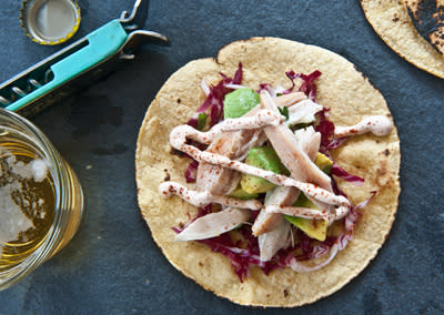 <div class="caption-credit"> Photo by: Photo by Sarah Flotard</div><b>Chicken Tacos with Shredded Cabbage, Avocado, and Sour Cream</b> <br> <br> Mix sour cream in a bowl with a squeeze of fresh lime juice and a pinch of ground ancho chiles. Mix diced chicken, diced avocado, and a bit of chopped cilantro in another bowl. Scatter finely shredded red cabbage, then chicken mixture over heated corn tortillas. Top with a generous drizzle of sour cream mixture.