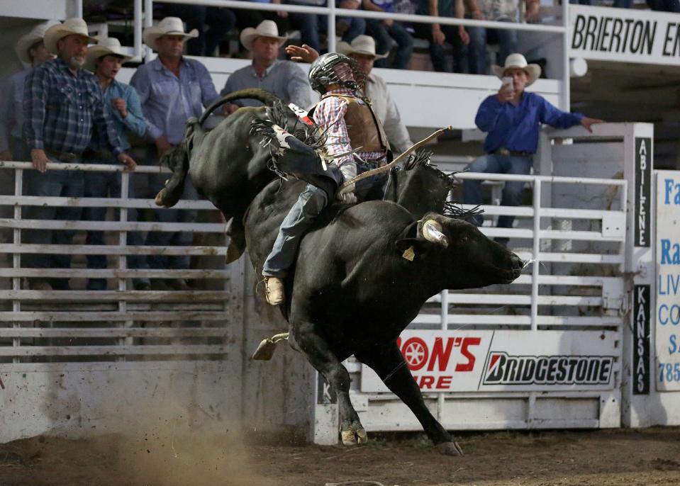 Coy Pollmeier from Fort Scott rides in the Bull Riding event during the 76th annual Wild Bill Hickok PRCA Rodeo Bulls, Broncs and Barrels night Wednesday, Aug. 3, 2022, at Eisenhower Park in Abilene.