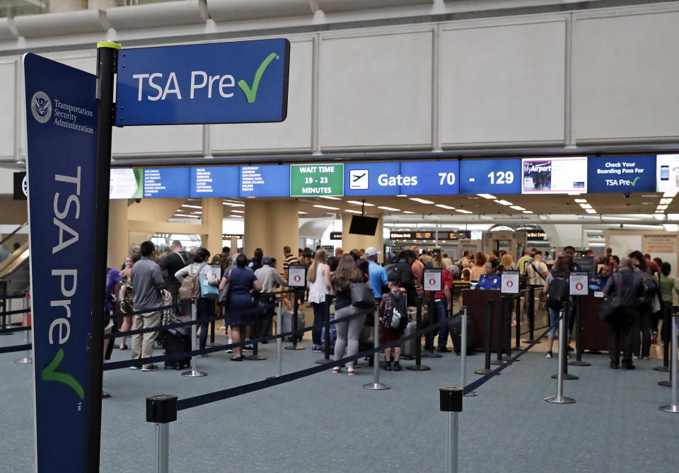 FILE- In this Thursday, June 21, 2018 photo, air passengers heading to their departure gates enter TSA pre-check before going through security screening at Orlando International Airport, in Orlando, Fla. Investigators were unable to corroborate specific allegations that a Transportation Security Administration supervisor instructed air marshals to racially discriminate against passengers at Florida's busiest airport. But investigators for the Department of Homeland Security's Office of Inspector General uncovered other concerns about racial profiling of passengers by other TSA supervisors at Orlando International Airport, according to a report sent to lawmakers last week. (AP Photo/John Raoux)