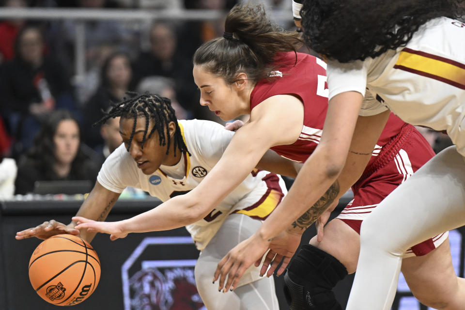 South Carolina forward Ashlyn Watkins (2) and Indiana forward Mackenzie Holmes (54) scramble for a loose ball during the first quarter of a Sweet Sixteen round college basketball game during the NCAA Tournament, Friday, March 29, 2024, in Albany, N.Y. (AP Photo/Hans Pennink)