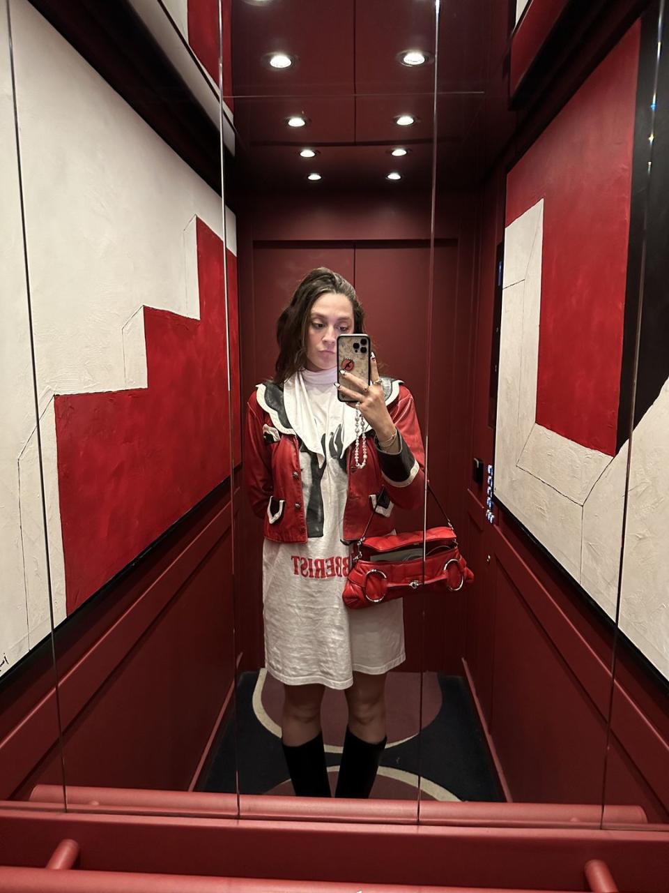 a woman taking a selfie in a mirror