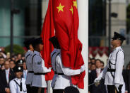 <p>The Chinese (R) and Hong Kong (L) flags are raised during a ceremony at Golden Bauhinia Square in Hong Kong on July 1, 2017 to celebrate the 20th anniversary of the establishment of the Hong Kong Special Administrative Region (HKSAR). (Photo: Dale de la Rey/AFP/Getty Images) </p>