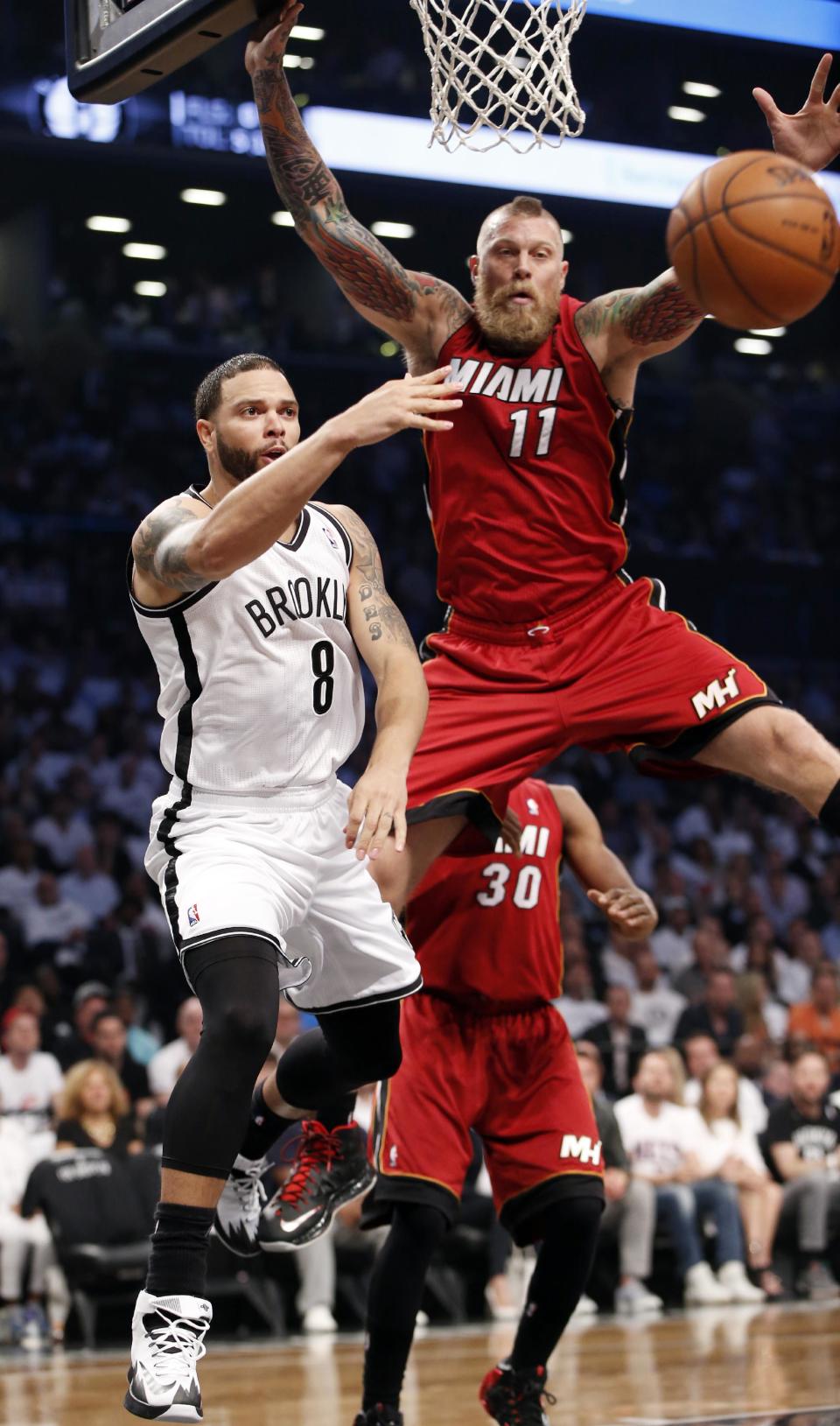 Brooklyn Nets guard Deron Williams (8) passes around Miami Heat forward Chris Andersen (11) in the first half of Game 4 of a second-round NBA playoff basketball game at the Barclays Center, Monday, May 12, 2014, in New York. (AP Photo)