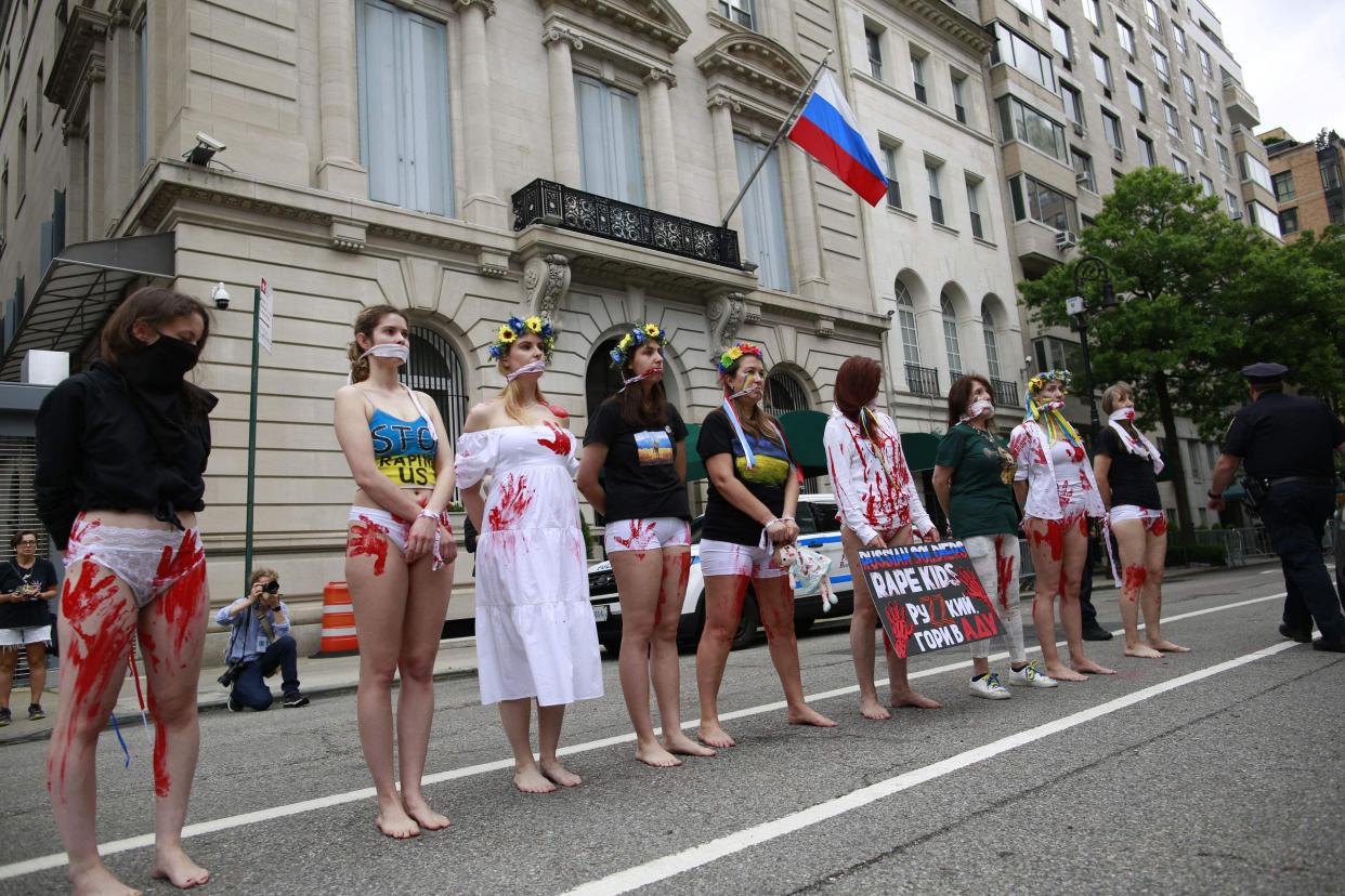 Activists protesting rape during war and supporting Ukraine stand in front of the Russian Consulate in New York on Saturday.