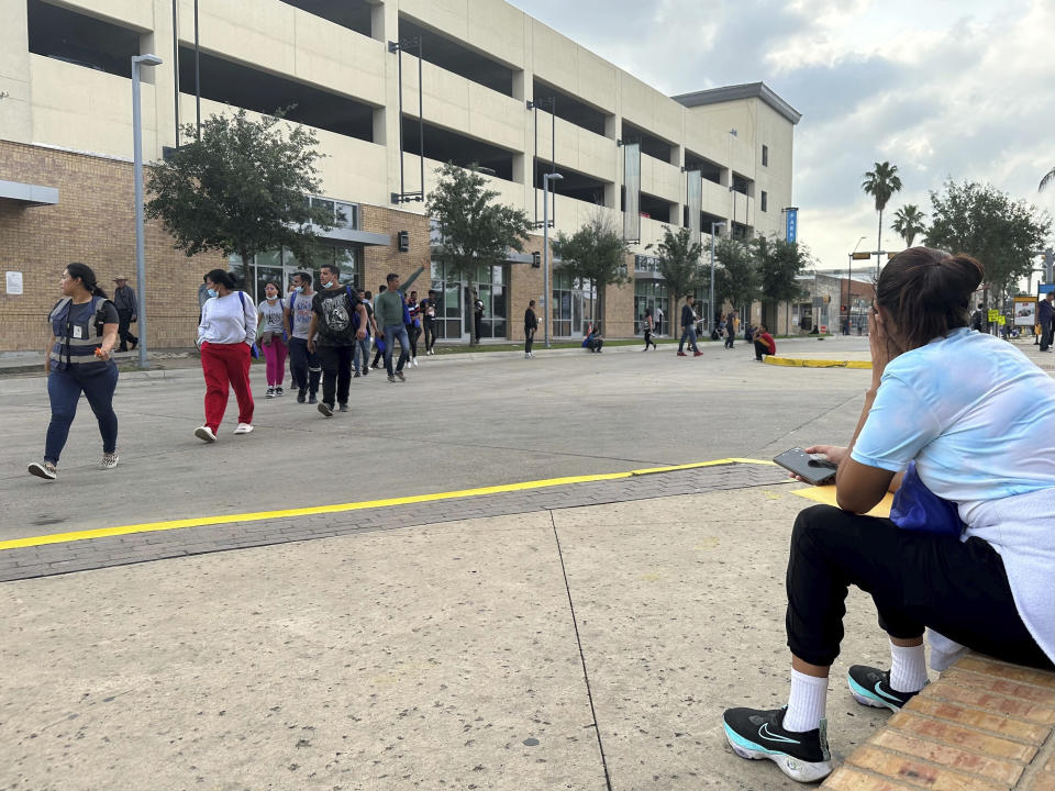 A group of people leave a welcome center for migrants in Brownsville, Texas, Friday, April 28, 2023. The city of Brownsville signed a disaster declaration after nearly 15,000 migrants crossed through the area, with many of them screened and released from federal custody and into the city. (AP Photo/Valerie Gonzalez)