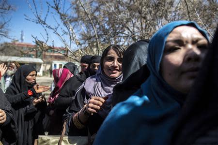 Afghan women queue to receive their voter cards at a voter registration centre in Kabul March 30, 2014. Afghan presidential elections will be held on April 5. REUTERS/Zohra Bensemra