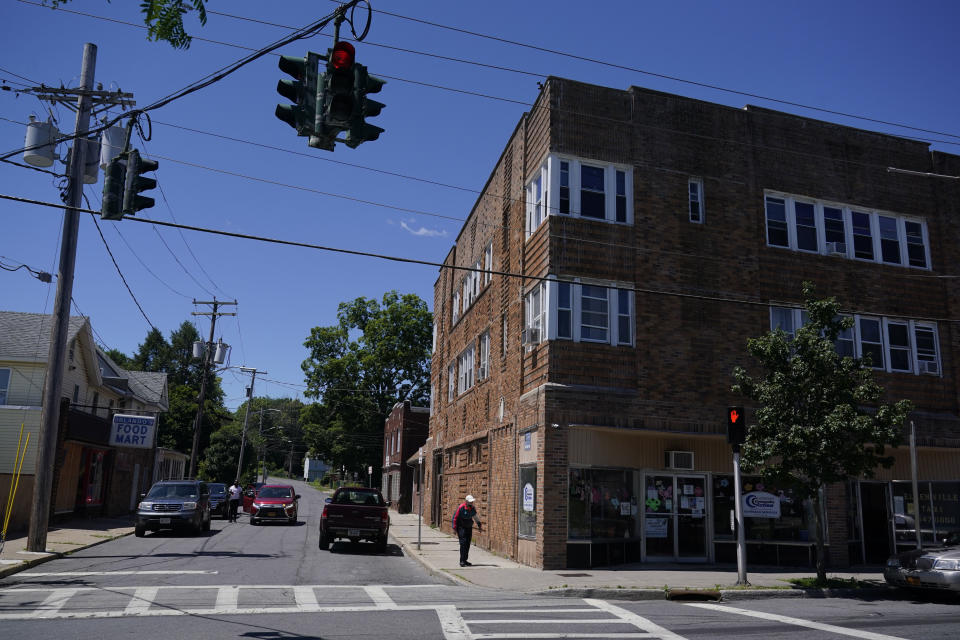 A man is dropped off on a corner in Ellenville, N.Y., Wednesday, June 16, 2021. Less than 100 miles north of New York City, Ulster County is popular destination for weekenders headed to Woodstock or the Catskill Mountains. Though pretty, there are pockets of poverty. The county is working with the Center for Guaranteed Income Research at the University of Pennsylvania on a pilot program funded by private donations. One hundred households making less than $46,900 a year in May began receiving a $500 payment each month for a year. Recipients of the money can spend it as they wish, but will be asked to participate in periodic surveys about their physical health, mental health and employment status. (AP Photo/Seth Wenig)