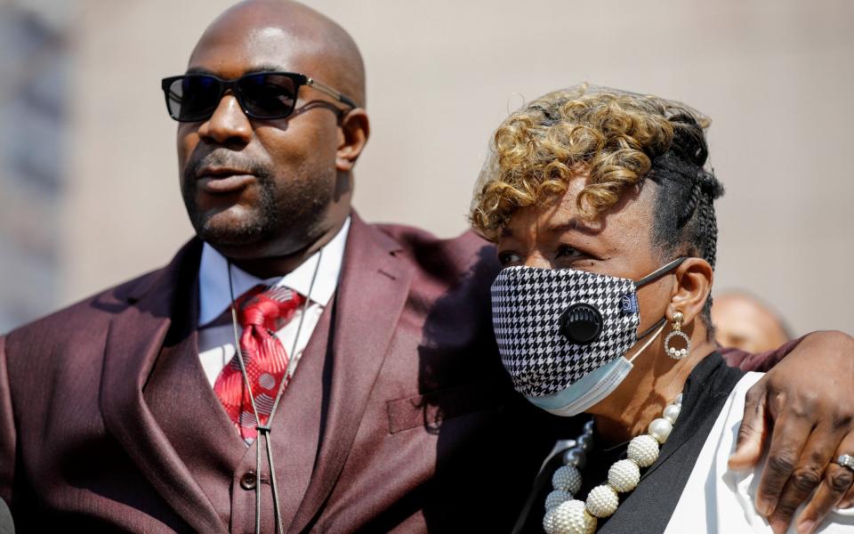 Gwen Carr, Eric Garner's mother, stands with Philonise Floyd outside the courthouse - Reuters