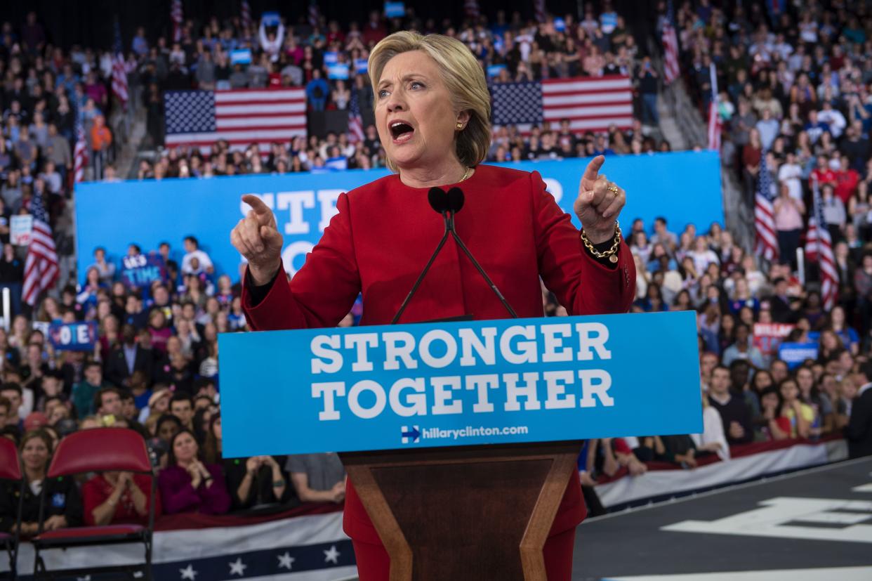 Then-Democratic presidential nominee Hillary Clinton at a rally in 2016 from a podium bearing the sign 