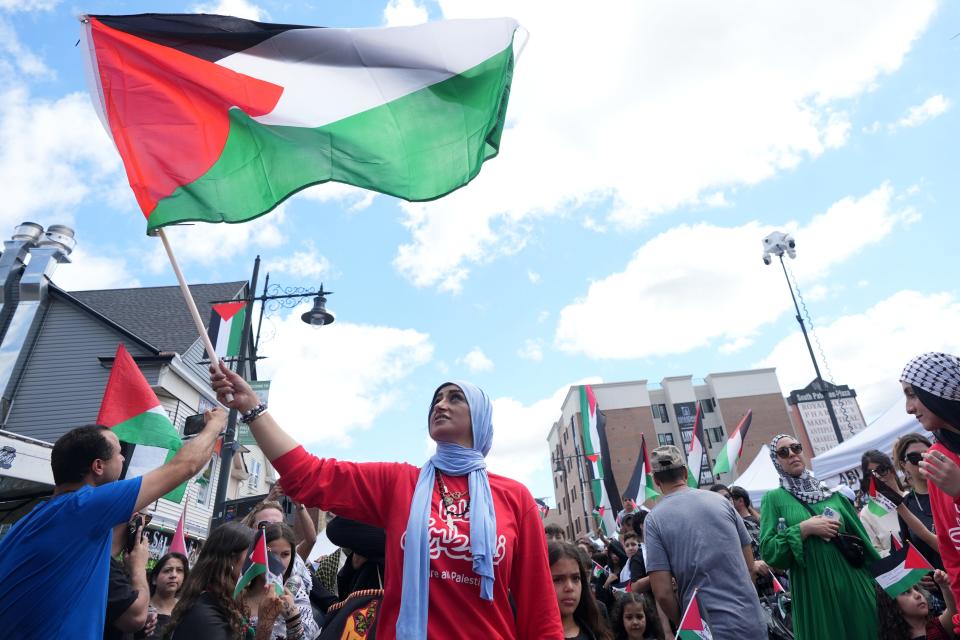 Feds Hassan, of Union City holds a Palestinian flag, Sunday, May 19, 2024, in Paterson.