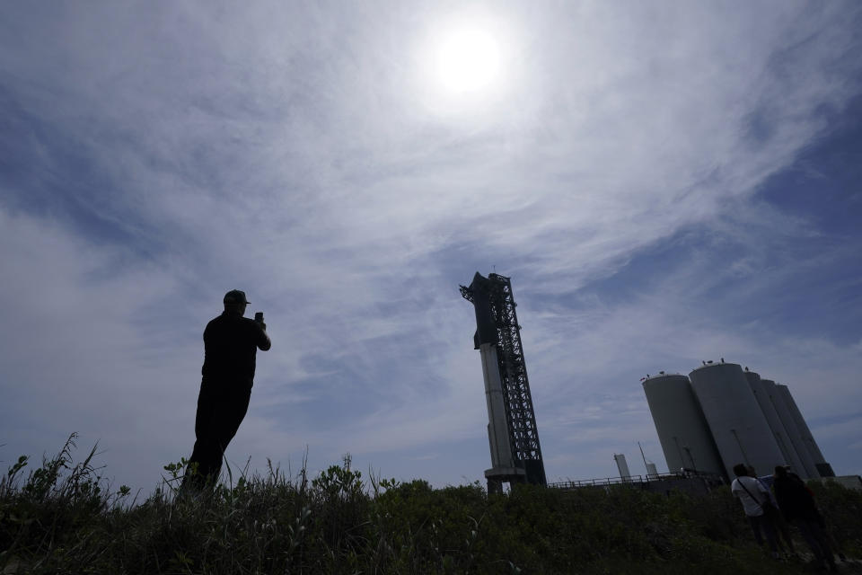A man photographs SpaceX's Starship, the world's biggest and most powerful rocket, sits ready for launch in Boca Chica, Texas, Sunday, April 16, 2023. The test launch is scheduled for Monday. (AP Photo/Eric Gay)