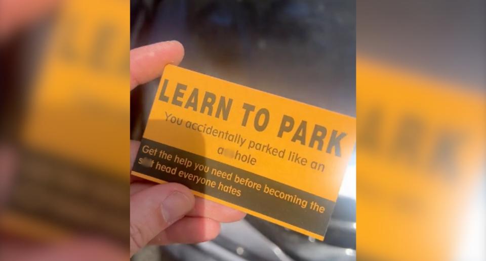 Image of the orange and black 'learn to park' card Ryan leaves after bad parking.