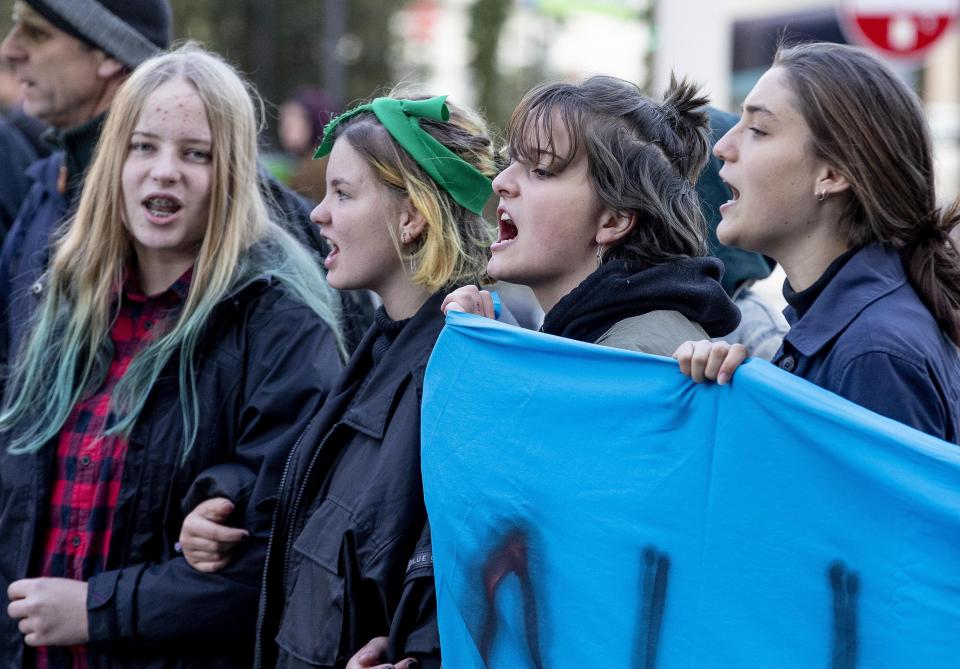 Activists block a road in Frankfurt, Germany, during rush hour on Friday, Sept. 20, 2019 as part of the 'Friday For Future' global strike. Protests are planned Friday in cities around the globe. In the United States more than 800 events were planned Friday, while in Germany more than 400 rallies are expected. (AP Photo/Michael Probst)