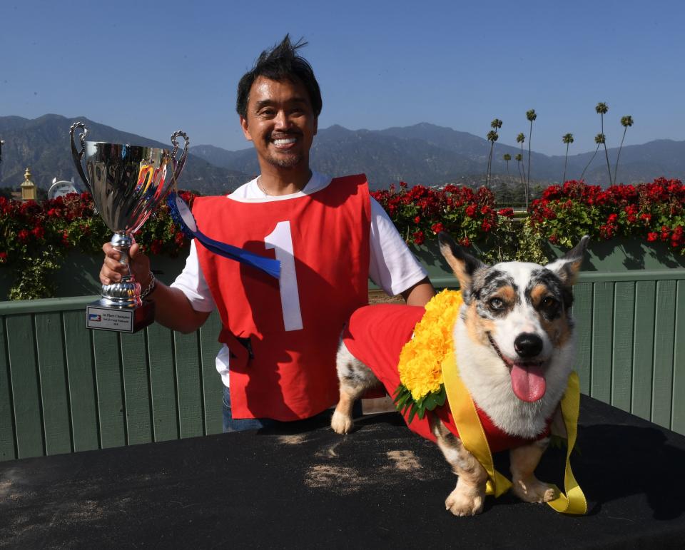 Rick Garcia celebrates with his dog, Roi, after winning the SoCal Corgi Nationals. (Photo: MARK RALSTON via Getty Images)