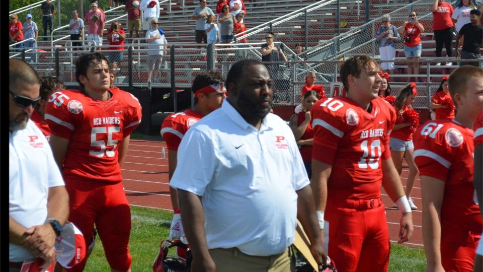 Paulsboro head football coach Kevin Harvey lines up with his team for the national anthem prior to their West Jersey Football League meeting with Haddonfield at Paulsboro's Bennett Field on Saturday, September 3, 2022.