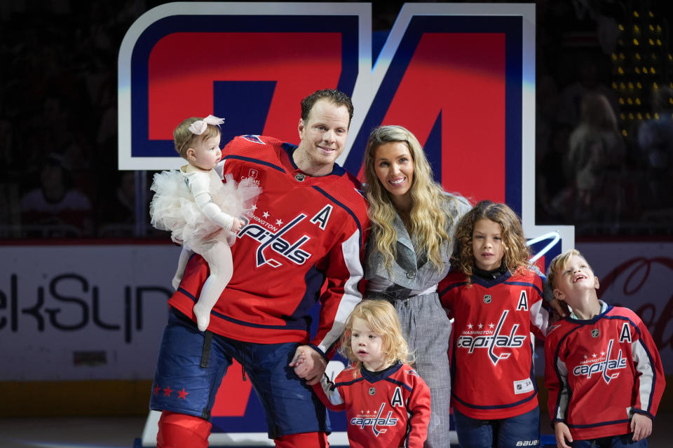 Washington Capitals defenseman John Carlson and his family pose for a photo during a ceremony to mark his playing in 1000 career NHL games before a hockey game against the Ottawa Senators, Sunday, April 7, 2024, in Washington. (AP Photo/Alex Brandon)