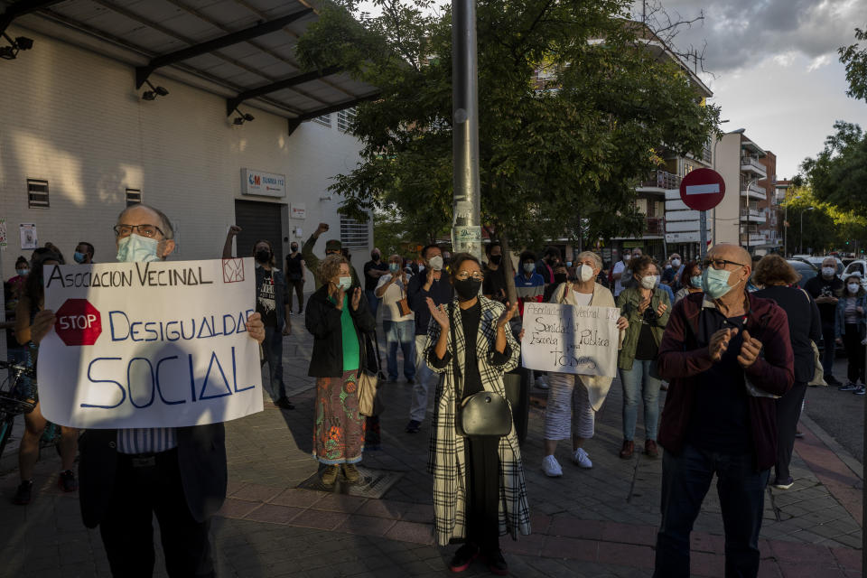 Residents of restricted mobility areas in Madrid due to the coronavirus outbreak gather during a protest to demand more resources for public health system and against social inequality in the southern neighbourhood of Vallecas, Madrid, Spain, Thursday, Sept. 24, 2020. Lower income people around the world have often suffered disproportionately from the pandemic for a number of reasons: their jobs might expose them more to the virus and their savings lower. In Spain their situation has been worse than much of the rest of Europe due to the particularly big role of industries like tourism and relatively weak social welfare benefits. (AP Photo/Bernat Armangue)