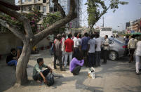 In this photo taken Sunday, Sept. 8, 2019, Indian daily wage laborers and construction workers wait to get hired on the outskirts of New Delhi, India. Confidence in the Indian economy is giving way to uncertainty as growth in the labor-intensive manufacturing sector has come to a near standstill, braking to 0.6% in the last quarter from 12.1% in the same period a year earlier. (AP Photo/Altaf Qadri)