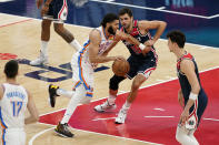 Oklahoma City Thunder forward Kenrich Williams, left, drives the ball against Washington Wizards guard Raul Neto in the first half of an NBA basketball game, Monday, April 19, 2021, in Washington. (AP Photo/Patrick Semansky)