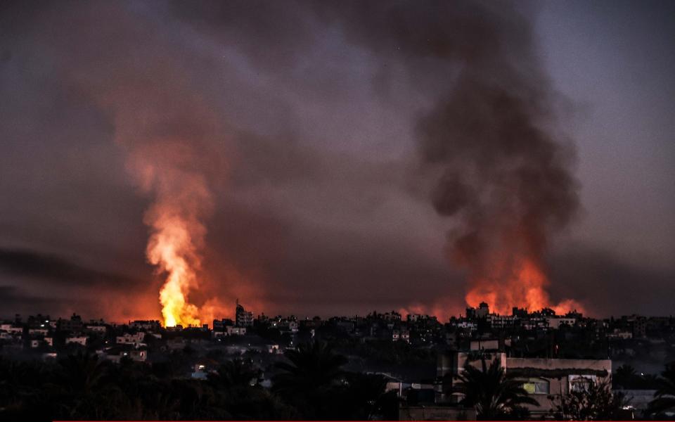 Smoke and flames rise from different parts of Salah al-Din Road following Israeli attacks in Deir Al Balah, Gaza