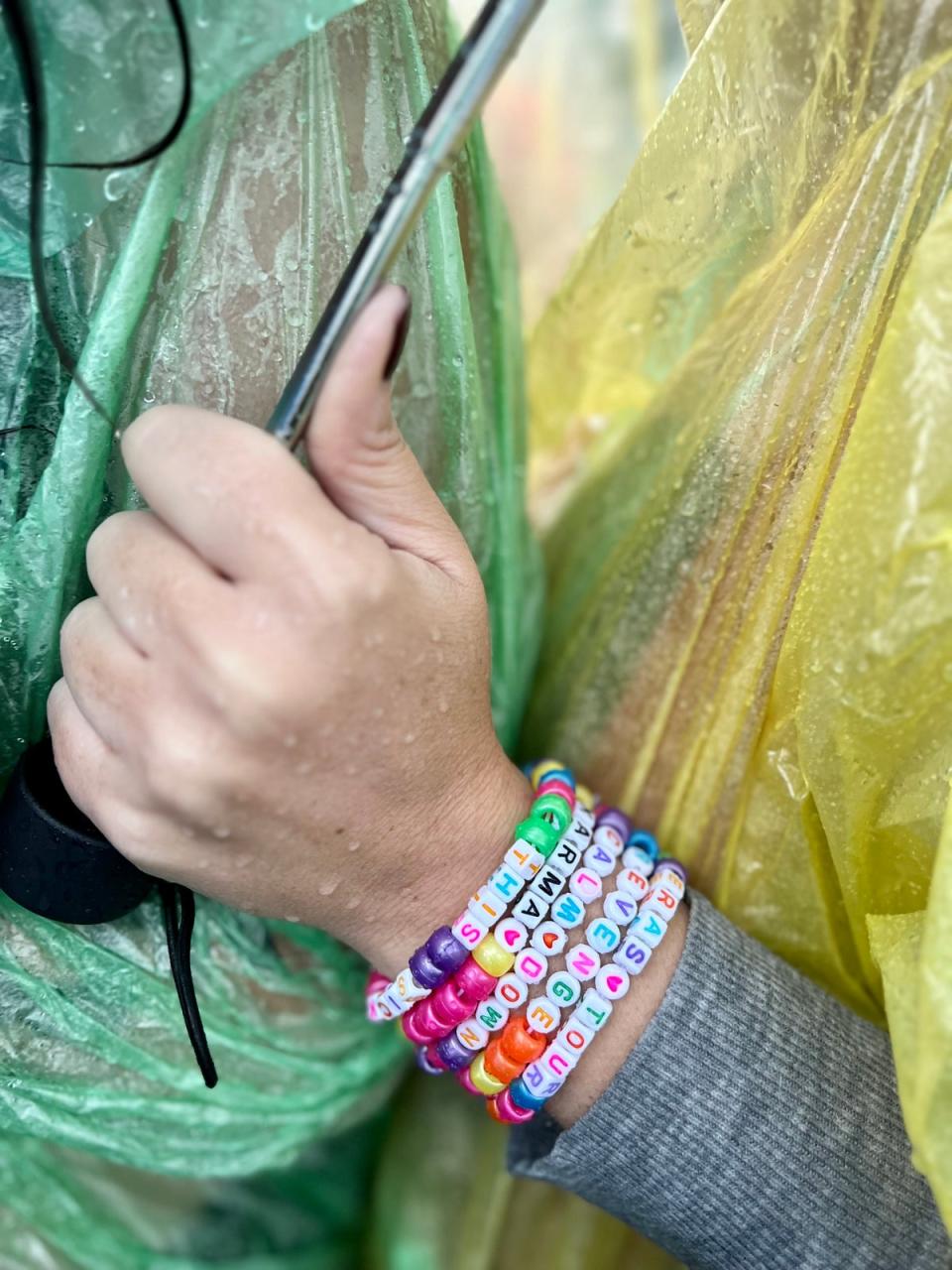 Swiftie waiting in the rain before Taylor’s cancelled concert (Andrea Cavallier / The Independent)