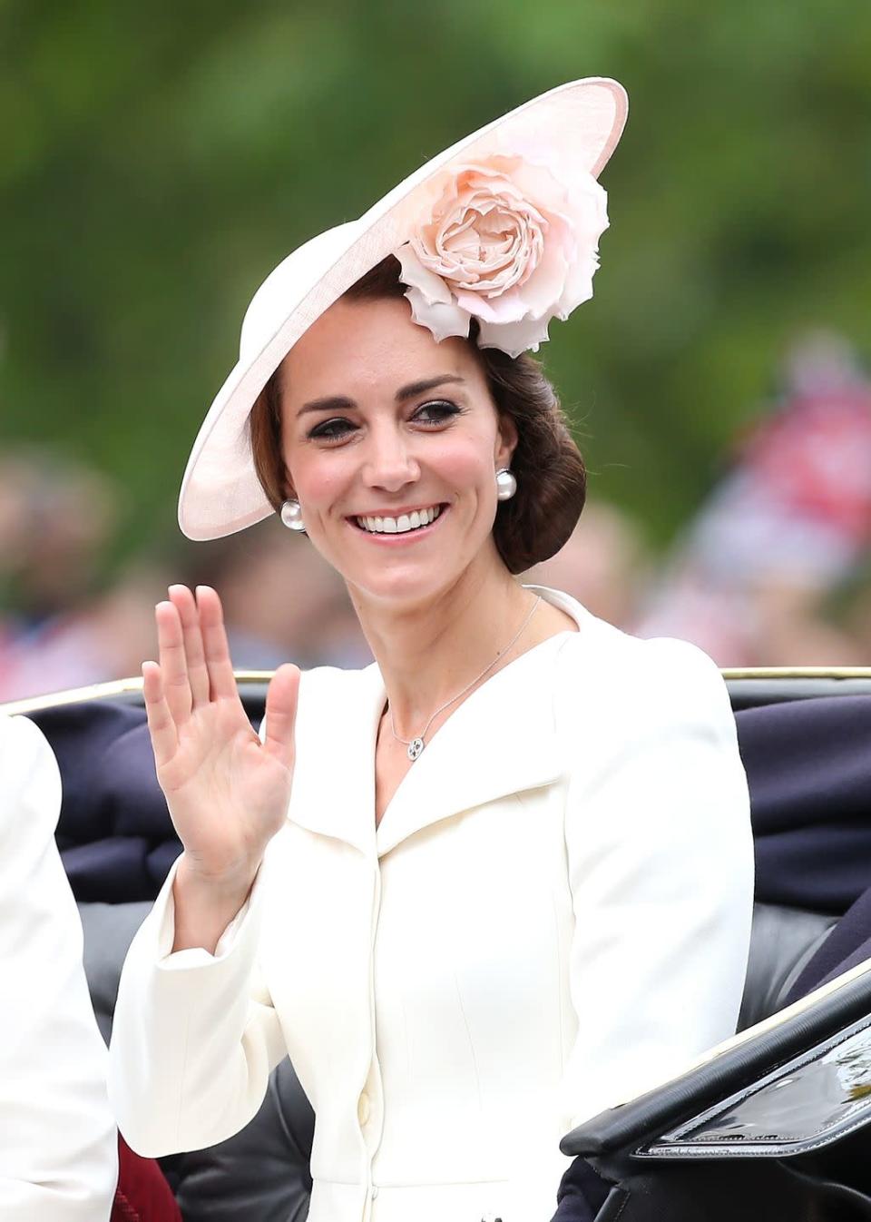 <p>Kate wore an old coat dress by Alexander McQueen, that she previously wore at Princess Charlotte's christening, and huge pearl earrings.</p>