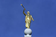 FILE - In this April 6, 2019 file photo, the angel Moroni statue sits atop the Salt Lake City temple during the The Church of Jesus Christ of Latter-day Saints' conference in Salt Lake City. For the third consecutive time, The Church of Jesus Christ of Latter-day Saints will hold its signature conference this weekend without attendees in person as the faith continues to take precautions amid the pandemic. Members of the Utah-based faith will instead watch on TVs, computers and tablets from their homes around the world Saturday, April 3, 2021 to hear spiritual guidance from the religion's top leaders, who will be delivering the speeches in Salt Lake City. (AP Photo/Rick Bowmer, File)