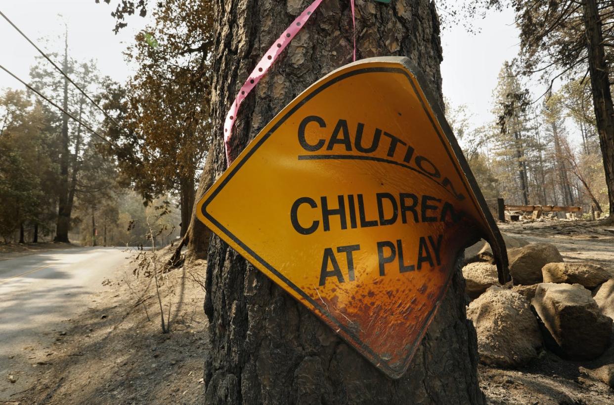 <span class="caption">A burned 'Caution: Children at play' sign remained after a wildfire devastated the town of Berry Creek, Calif., in 2020.</span> <span class="attribution"><a class="link " href="https://www.gettyimages.com/detail/news-photo/berry-creek-california-sept-17-2020-a-melted-sign-warning-news-photo/1228658291" rel="nofollow noopener" target="_blank" data-ylk="slk:Carolyn Cole/Los Angeles Times via Getty Images;elm:context_link;itc:0;sec:content-canvas">Carolyn Cole/Los Angeles Times via Getty Images</a></span>