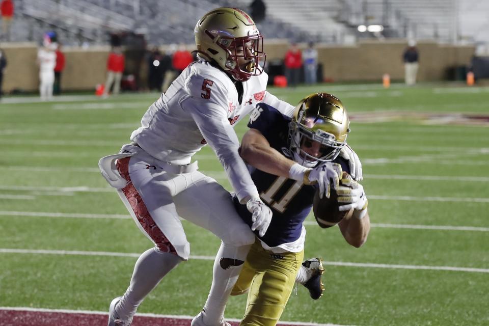 Notre Dame wide receiver Ben Skowronek (11) makes a touchdown reception against Boston College defensive back Deon Jones (5) during the first half of an NCAA college football game, Saturday, Nov. 14, 2020, in Boston. (AP Photo/Michael Dwyer)