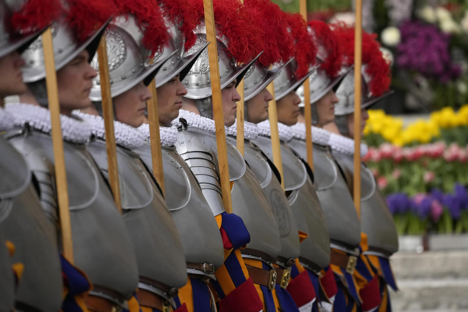 Vatican Swiss Guards stand in St. Peter's Square at The Vatican where Pope Francis will celebrate the Easter Sunday mass, Sunday, March 31, 2024. (AP Photo/Andrew Medichini)