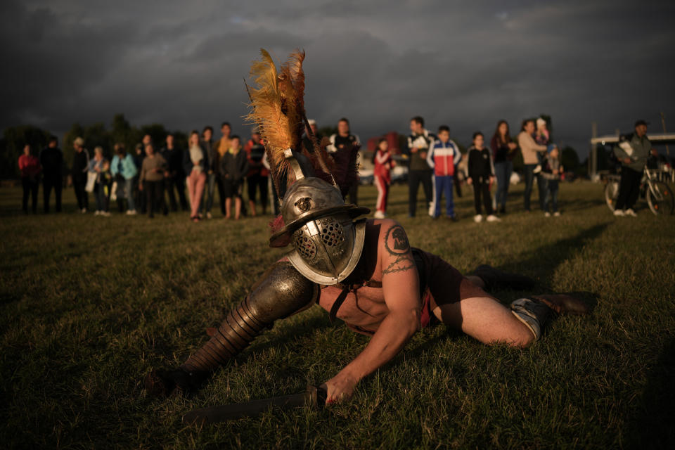 Participants in the Romula Fest event reenact Roman Empire era gladiator fights in the village of Resca, Romania, Saturday, Sept. 3, 2022. Members of historic NGOs and volunteers gathered in a field outside a southern Romanian village, once part of the Romula Malva, Roman Empire era city, aiming to raise awareness for history through realistic reenactments of battles between Roman legions and local Dacian tribes.(AP Photo/Vadim Ghirda)