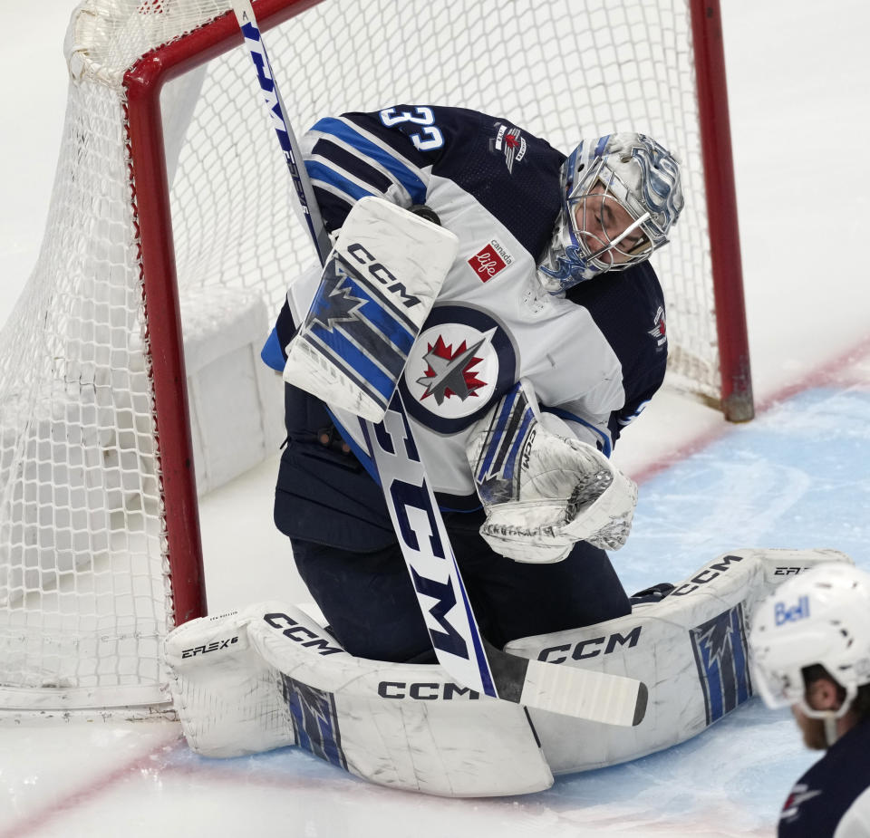 Winnipeg Jets goaltender David Rittich makes a glove save against the Colorado Avalanche during the first period of an NHL hockey game Thursday, April 13, 2023, in Denver. (AP Photo/David Zalubowski