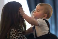 Catherine, Duchess of Cambridge, holds her son Prince George during a Plunket nurse and parents' group event at Government House in Wellington April 9, 2014. Plunket is a national not-for-profit organisation that provides care for children and families in New Zealand. Britain's Prince William and his wife Kate are undertaking a 19-day official visit to New Zealand and Australia with their son George. REUTERS/Marty Melville/Pool (NEW ZEALAND - Tags: ROYALS ENTERTAINMENT)