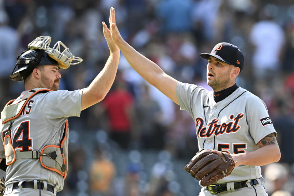 Detroit Tigers' Jake Rogers, left, and Alex Lange celebrate the team's 4-1 win over the Cleveland Guardians in a baseball game, Sunday, Aug. 20, 2023, in Cleveland. (AP Photo/Nick Cammett)