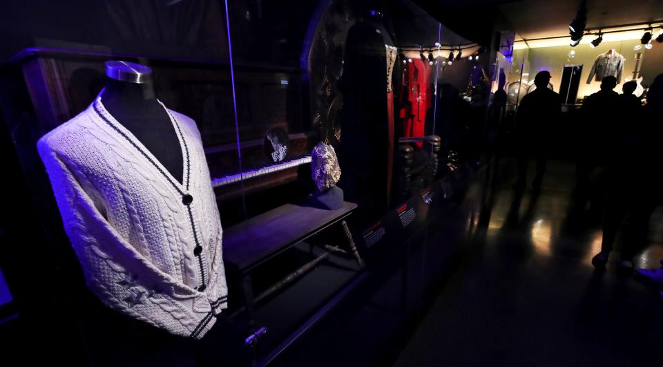 The sweater Taylor Swift wore in her 2020 music video for her song "cardigan" is on display along with other pieces during the Taylor Swift Fan Day at the Rock & Roll Hall of Fame Friday.