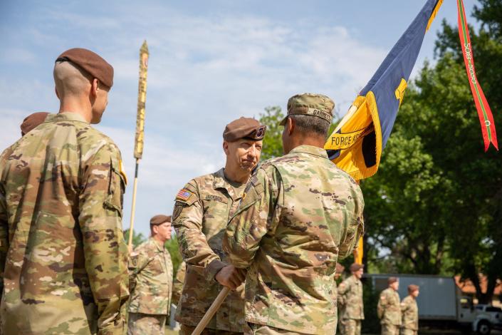 Maj. Gen. Scott Jackson hands the Security Force Assistance Command's colors to Gen. Michael Garrett, as he relinquishes the command to Maj. Gen. Donn Hill during a May 16, 2022, ceremony at Fort Bragg.