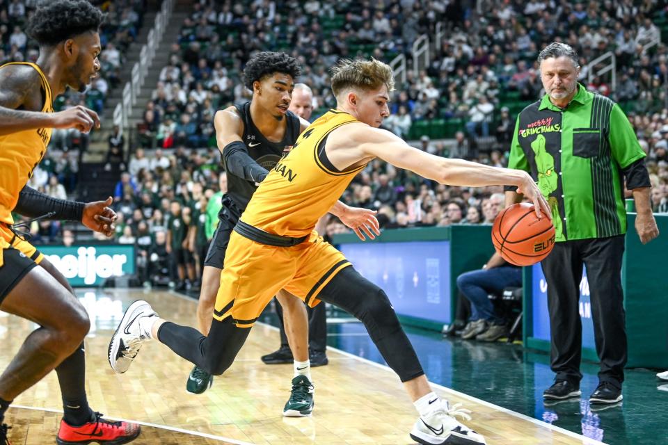 Oakland's Blake Lampman, right, steals the ball as Michigan State's Jaden Akins closes in during the first half on Wednesday, Dec. 21, 2022, at the Breslin Center in East Lansing.