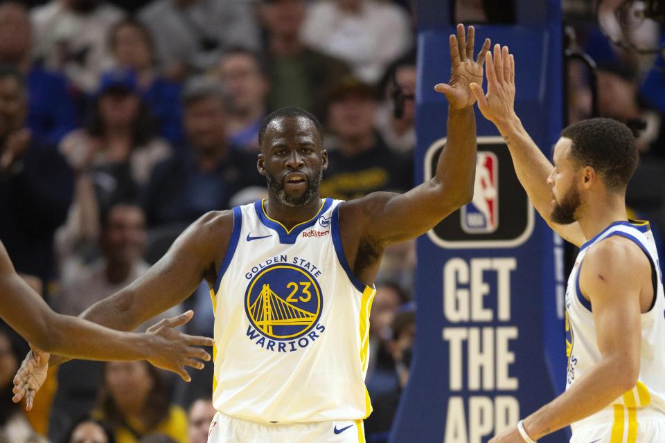 Golden State Warriors forward Draymond Green (23) celebrates with guard Stephen Curry after Green was fouled on a made basket against the Philadelphia 76ers during the first half of an NBA basketball game, Tuesday, Jan. 30, 2024, in San Francisco. (AP Photo/D. Ross Cameron)