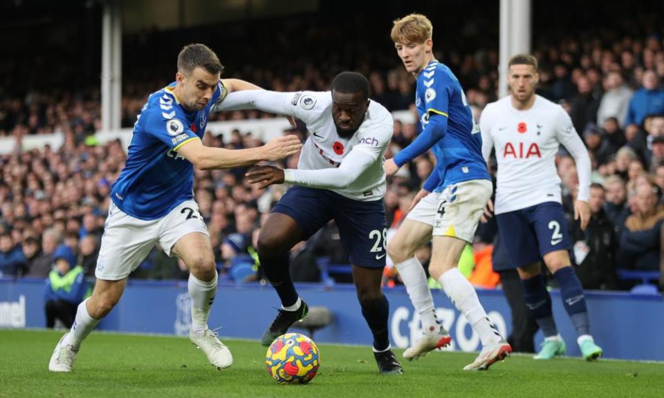 Tanguy Ndombele of Tottenham Hotspur battles for possession with Seamus Coleman and Anthony Gordon of Everton.