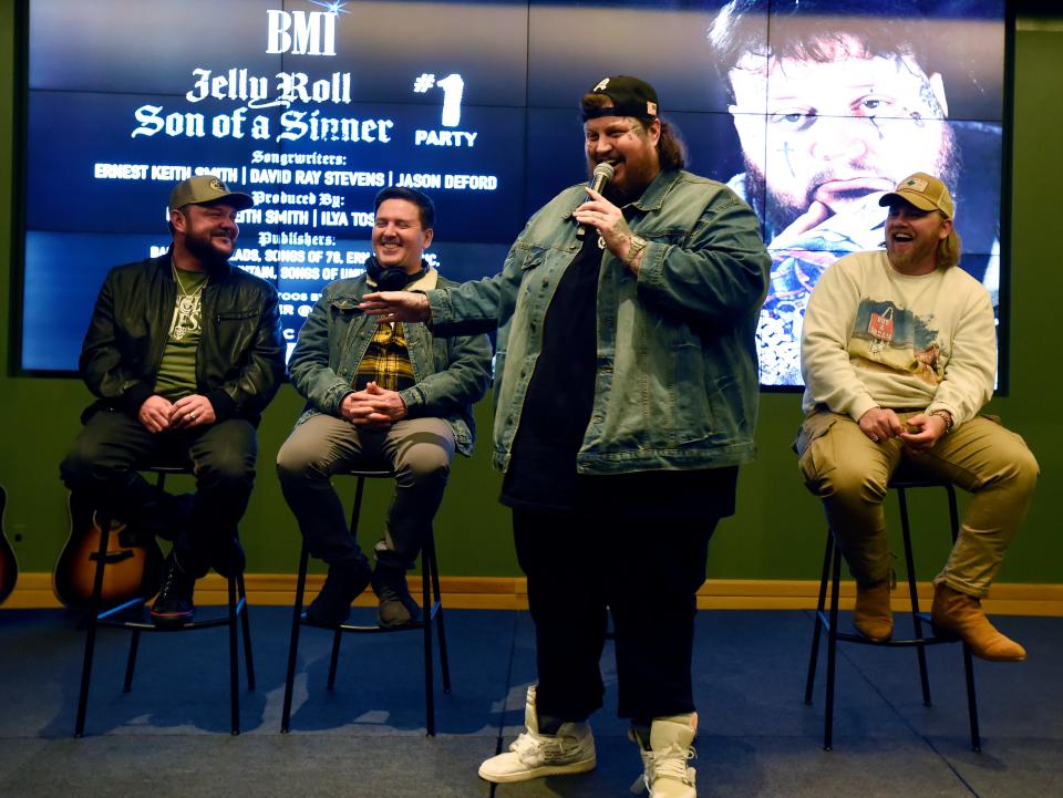 Singer Jelly Roll talks about songwriter David Ray Stevens, left, producer Ilya Toshinsky, and songwriter Ernest Keith Smith, right,  during a ceremony for their No. 1 song “Son of a Sinner” at BMI on Wednesday, Jan. 18, 2023, in Nashville, Tenn.   