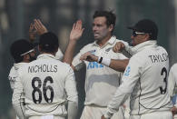 New Zealand's Tim Southee, centre, celebrates the wicket of India's Ravindra Jadeja with his teammates during the day four of their first test cricket match in Kanpur, India, Sunday, Nov. 28, 2021. (AP Photo/Altaf Qadri)