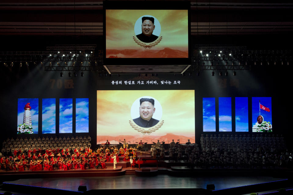 Portraits of North Korean leader Kim Jong Un is displayed on a large screen with the words "We will go and go along the road of loyalty, Shining Fatherland" during a evening gala performance on the eve of the 70th anniversary of North Korea's founding day in Pyongyang, North Korea, Saturday, Sept. 8, 2018. North Korea will be staging a major military parade, huge rallies and reviving its iconic mass games on Sunday to mark its 70th anniversary as a nation. (AP Photo/Ng Han Guan)