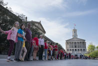 FILE - Demonstrators hold hands and lock arms with each other during the "Arms Are for Hugging" protest for gun control legislation, April 18, 2023, in Nashville, Tenn. Participants created a human chain starting from Monroe Carell Jr. Children's Hospital at Vanderbilt, where victims of The Covenant School shooting were taken on March 27, and ending at the Tennessee Capitol. Documents obtained by The Associated Press show Tennessee Gov. Bill Lee’s administration accused the National Rifle Association of wanting to use involuntary commitment laws "to round up mentally ill people and deprive them of other liberties." (AP Photo/George Walker IV, File)