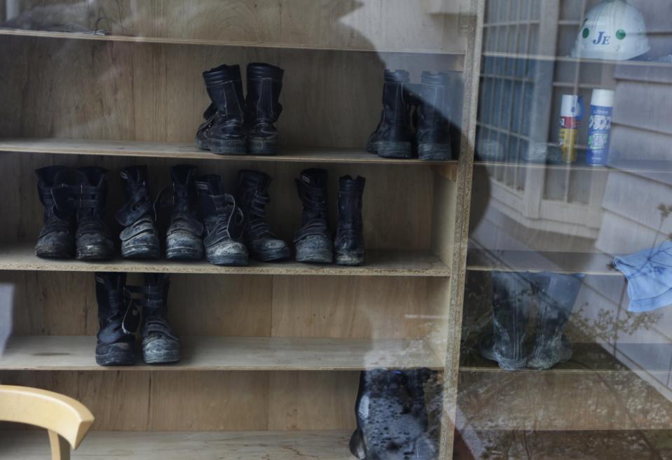 Workers' boots are seen through a window at Shuto Kogyo's dormitory for workers in Tome, Miyagi prefecture