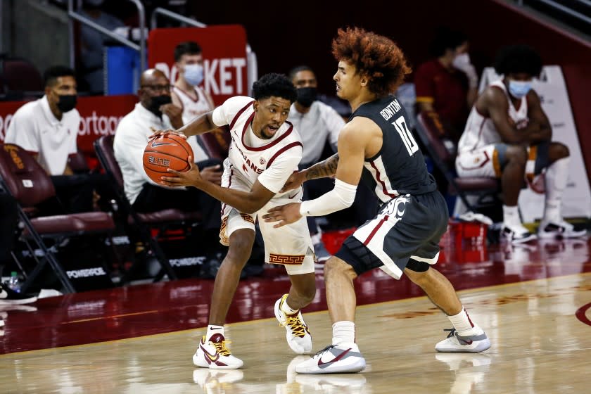 USC guard Tahj Eaddy, left, is defended by Washington State's Isaac Bonton on Jan. 16, 2021, in Los Angeles.